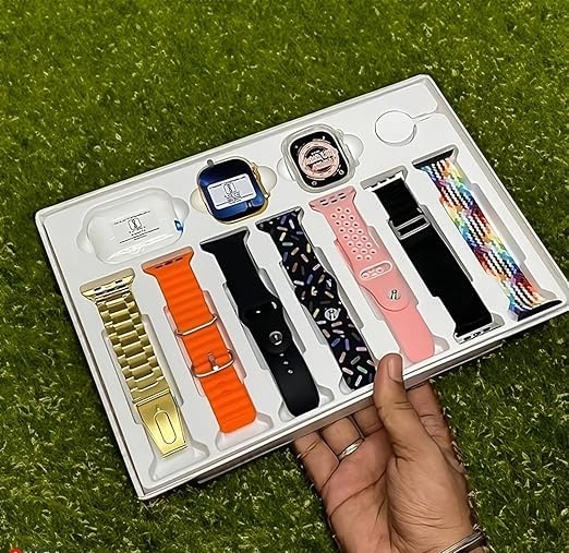 Set of watch straps in a box held by a hand on a grassy background